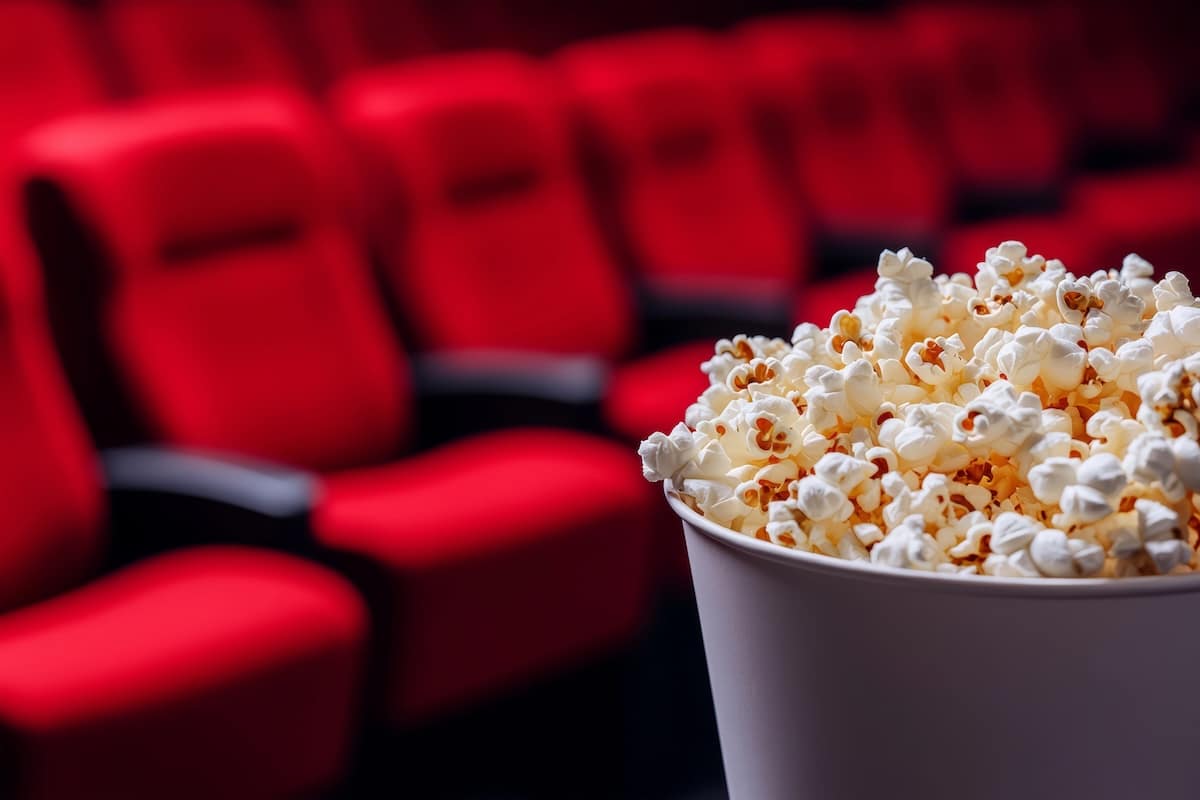 Fauteuils rouges et pop-corn dans une salle de cinéma